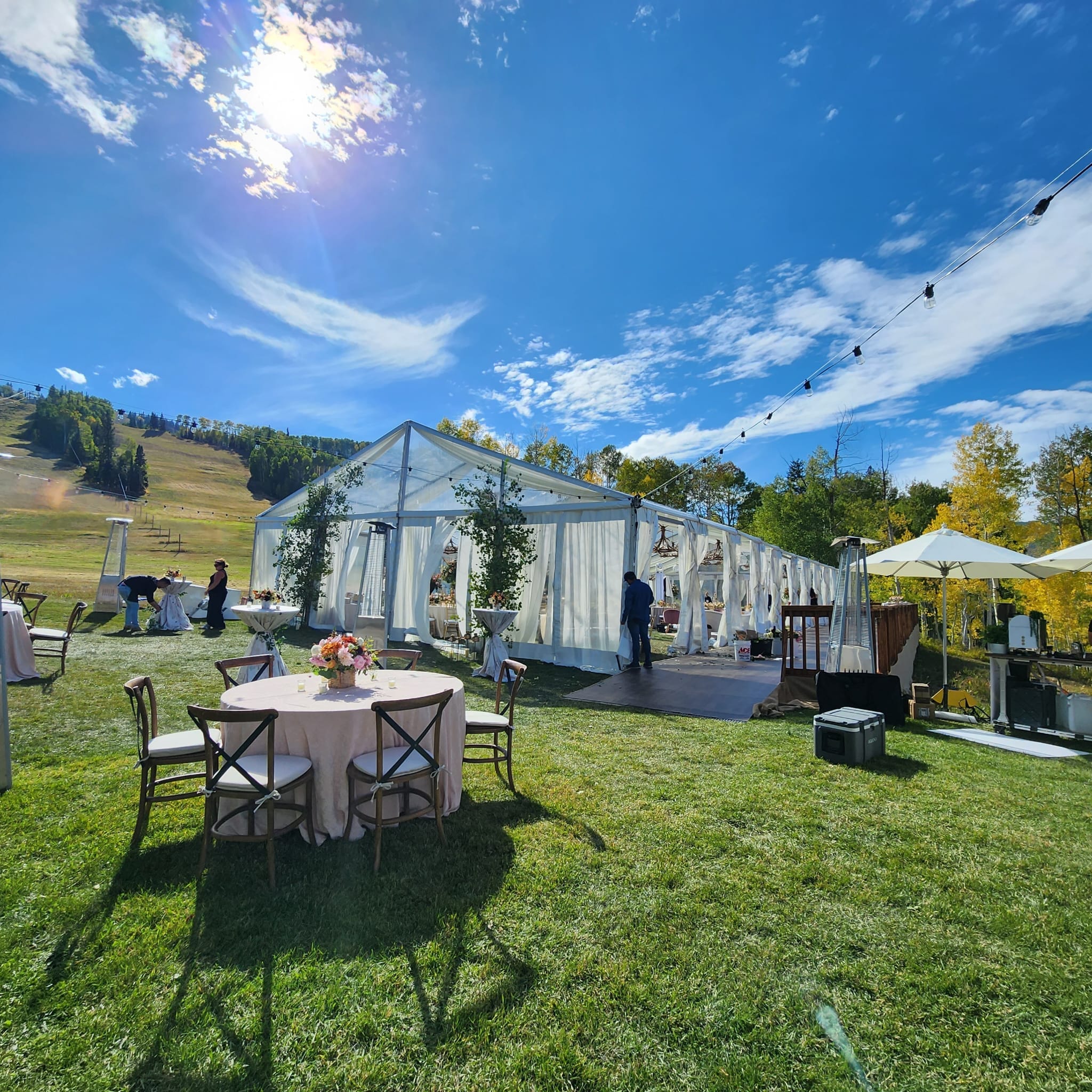 outdoor wedding reception with large tent and tables and chairs on lawn