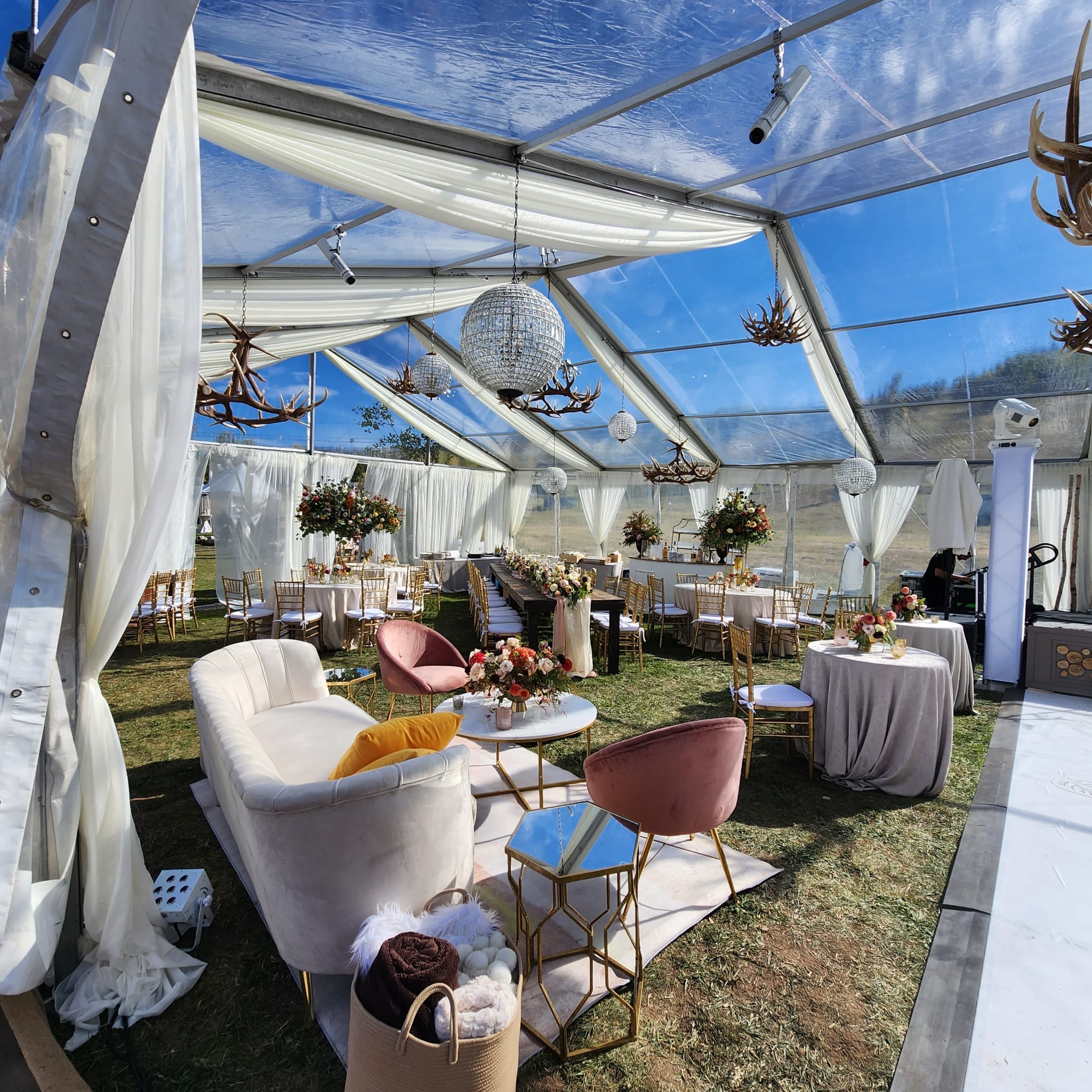 clear tent renal with dining tables and sitting area