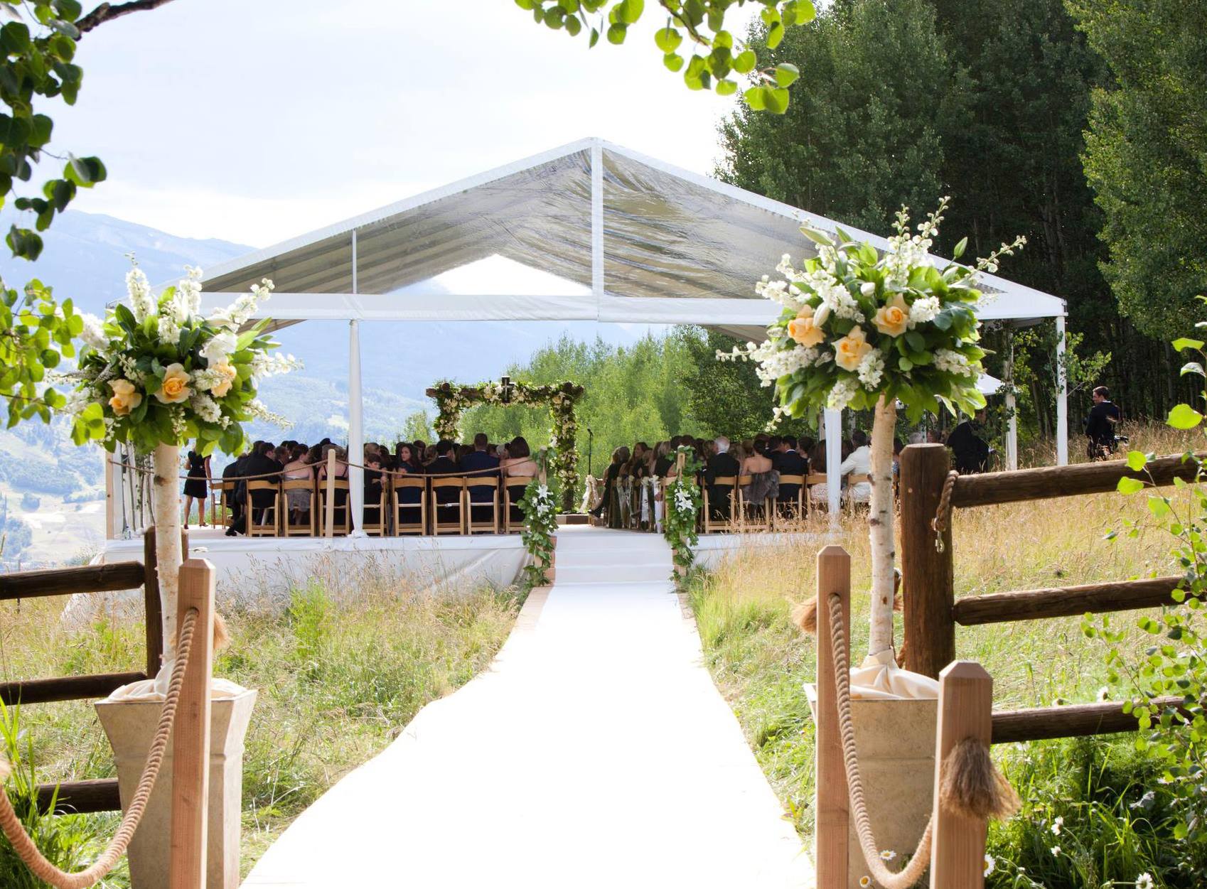 wedding ceremony overlooking mountains under tent